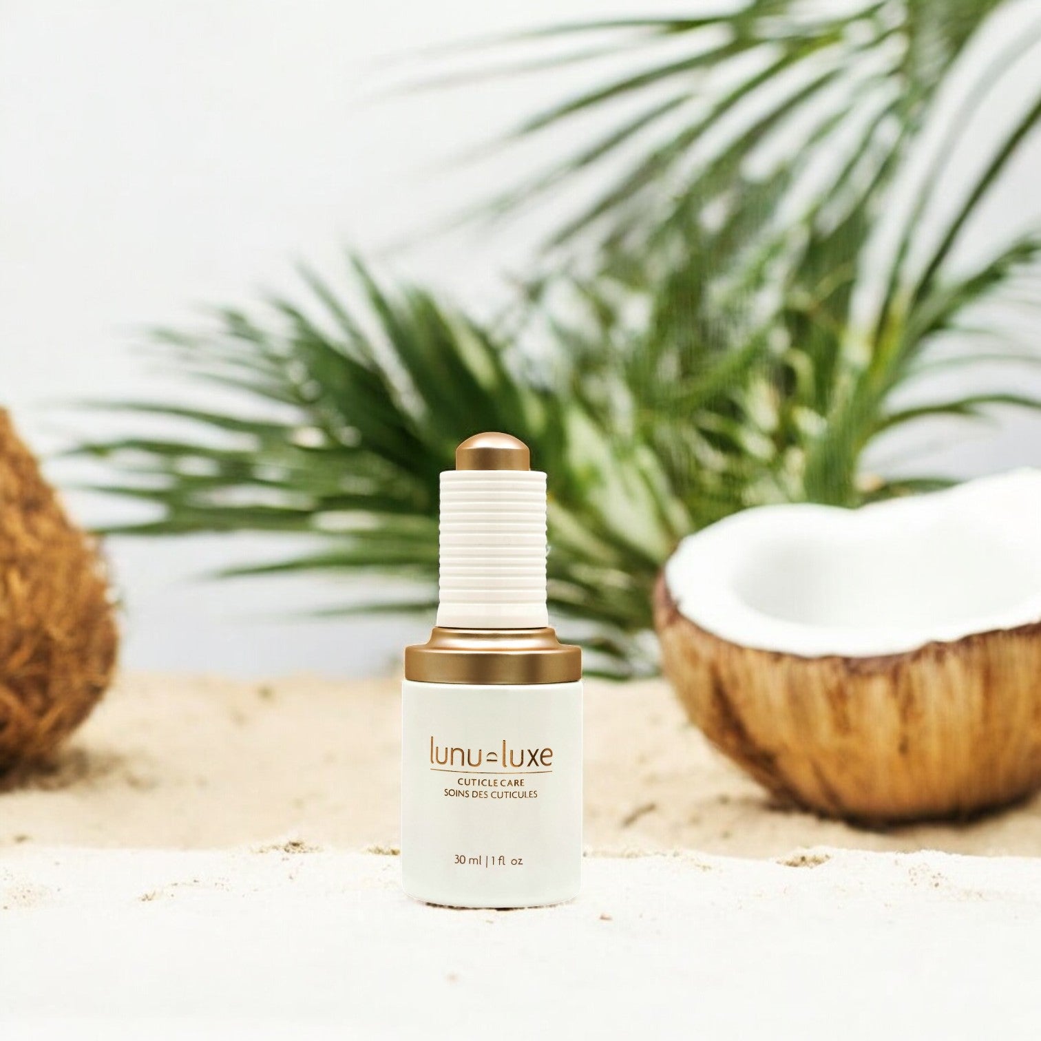 Cuticle oil bottle with coconuts and palm trees behind it.